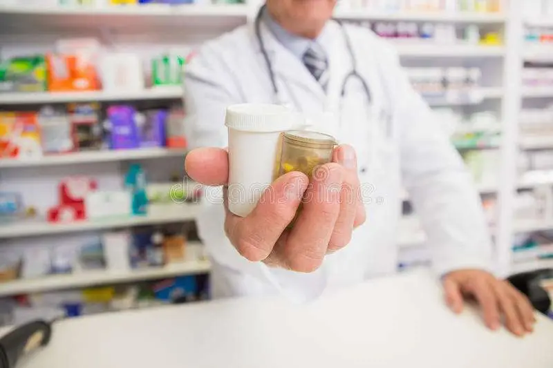 Pharmacist Presenting Medications On His Hand Stock Image